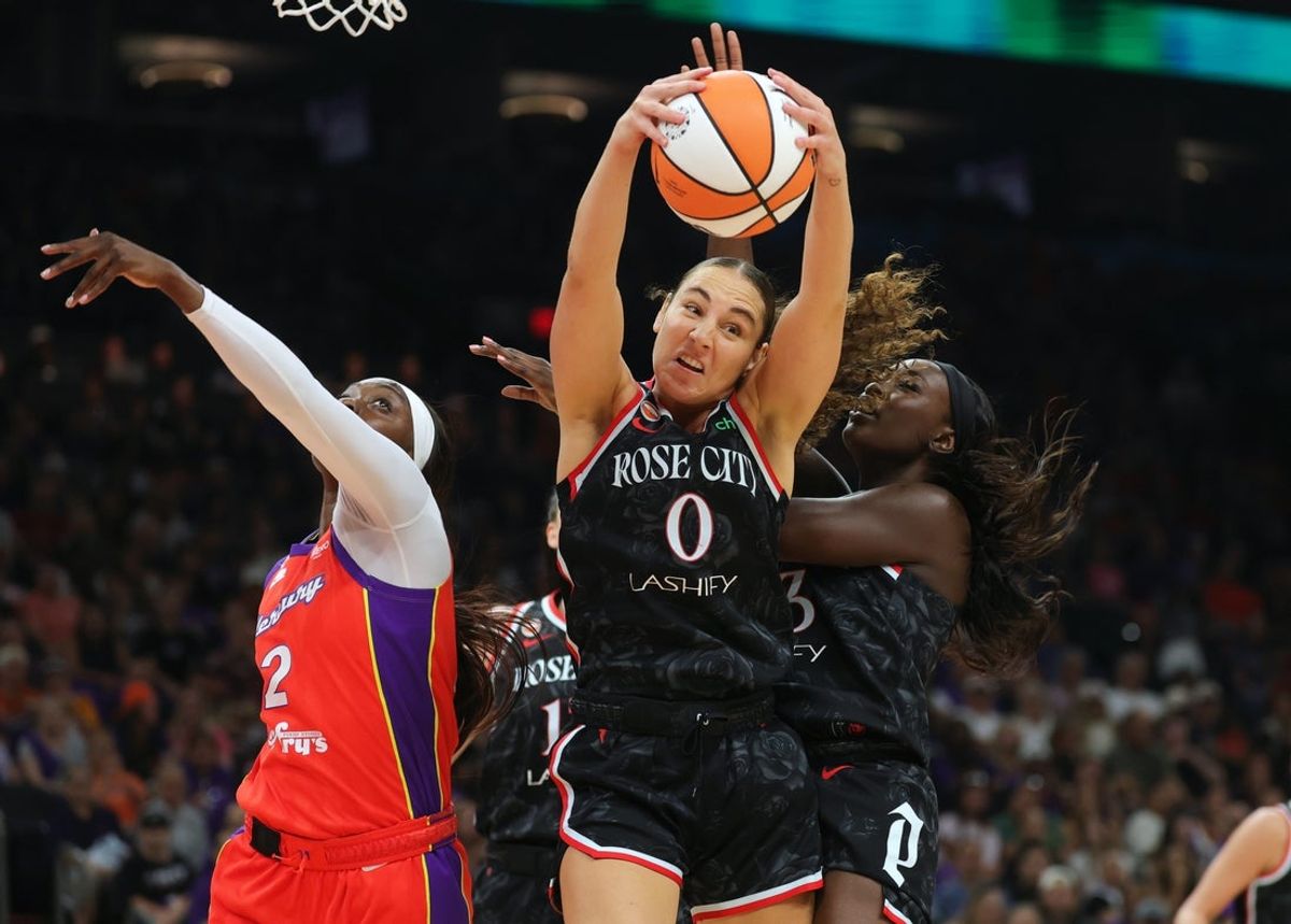 Aug 16, 2026; Phoenix, Arizona, USA; Portland Fire guard Carla Leite (0) grabs a rebound against Phoenix Mercury guard Kahleah Copper (2) in the first half at Mortgage Matchup Center. Mandatory Credit: Mark J. Rebilas-Imagn Images