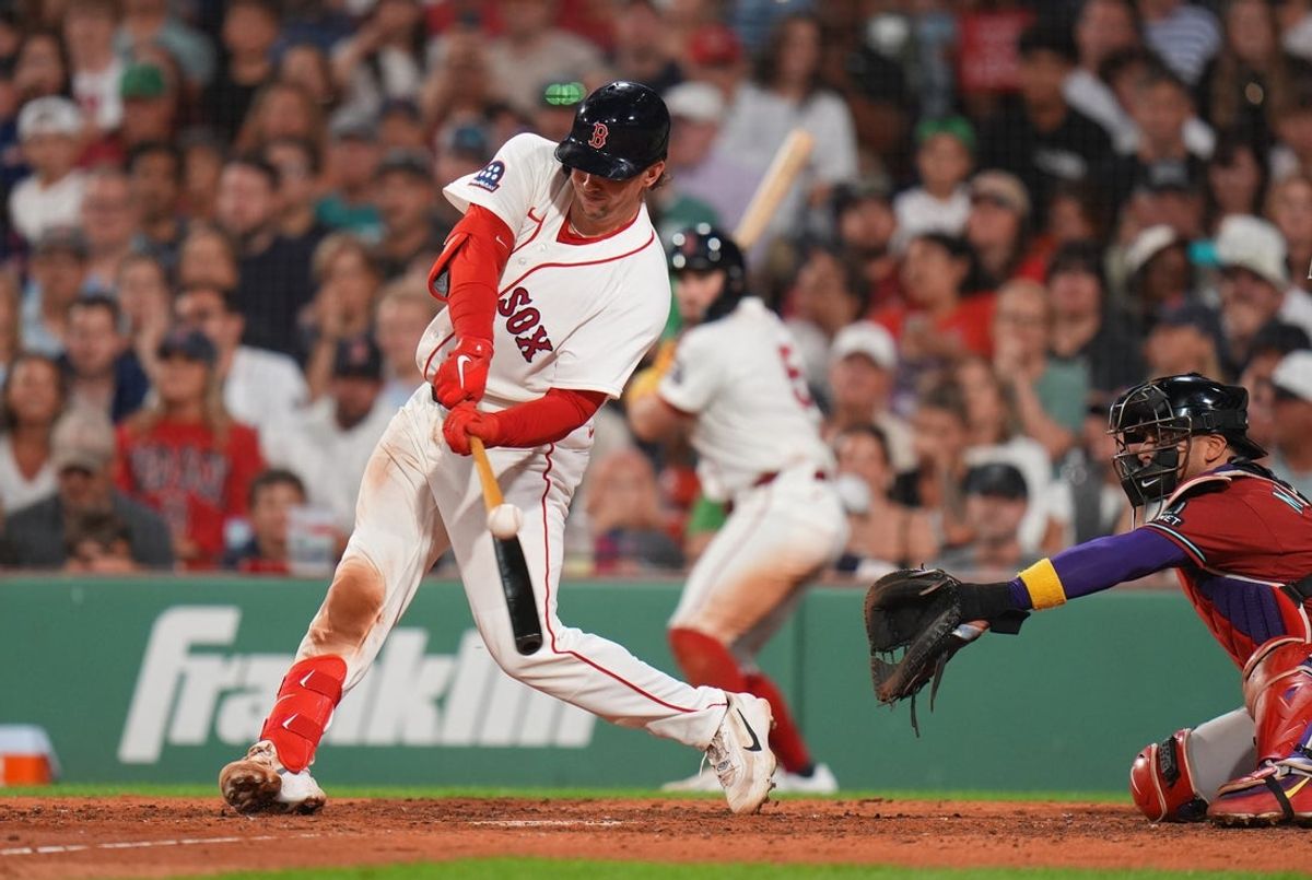 Aug 17, 2026; Boston, Massachusetts, USA; Boston Red Sox catcher Adley Rutschman (31) hits a double to drive in a run against the Arizona Diamondbacks in the sixth inning at Fenway Park. Mandatory Credit: David Butler II-Imagn Images
