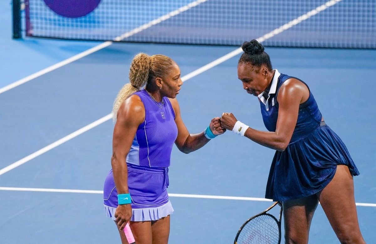 Serena Williams and her sister, Venus Williams, bump fists during a doubles match at the Cincinnati Open at the Lindner Family Tennis Center in Mason on Aug. 17, 2026. The sisters fell to Marta Kostyuk and Peyton Stearns, 6-2, 1-6, 10-8.