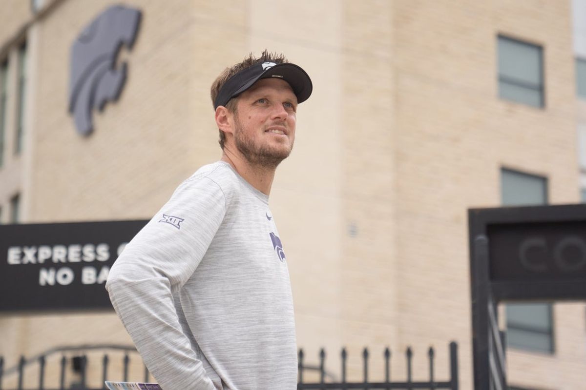 Kansas State coach Collin Klein waits for players to walk towards the indoor facility during practice at Kansas State University on Aug. 18, 2026.