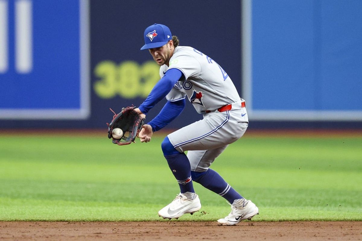 Aug 18, 2026; St. Petersburg, Florida, USA; Toronto Blue Jays second baseman Ernie Clement (22) fields theball against the Tampa Bay Rays in the second inning at Tropicana Field. Mandatory Credit: Nathan Ray Seebeck-Imagn Images