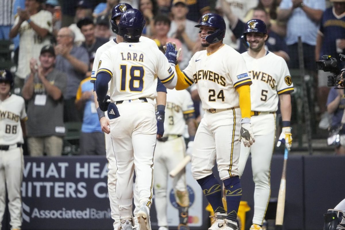 Aug 18, 2026; Milwaukee, Wisconsin, USA; Milwaukee Brewers right fielder Luis Lara (18) is congratulated by catcher William Contreras (24) after hitting a home run against the Seattle Mariners in the eighth inning at American Family Field. Mandatory Credit: Michael McLoone-Imagn Images