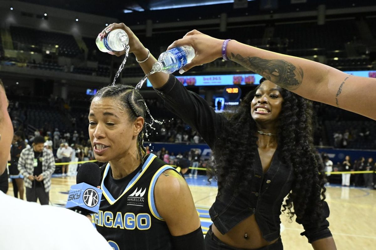 Aug 18, 2026; Chicago, Illinois, USA;  Chicago Sky guard Natasha Cloud (9), left, is sprayed with water after the game against the New York Liberty  at Wintrust Arena. Mandatory Credit: Matt Marton-Imagn Images