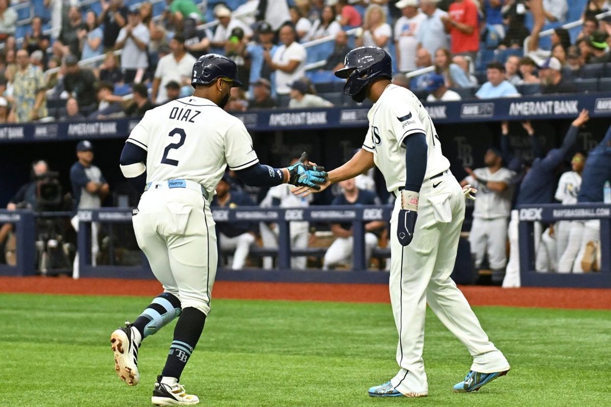Aug 19, 2026; St. Petersburg, Florida, USA; Tampa Bay Rays designated hitter Yandy Diaz (2) celebrates with third baseman Junior Caminero (13) after hitting a two run home run in the first inning against the Toronto Blue Jays at Tropicana Field. Mandatory Credit: Jonathan Dyer-Imagn Images