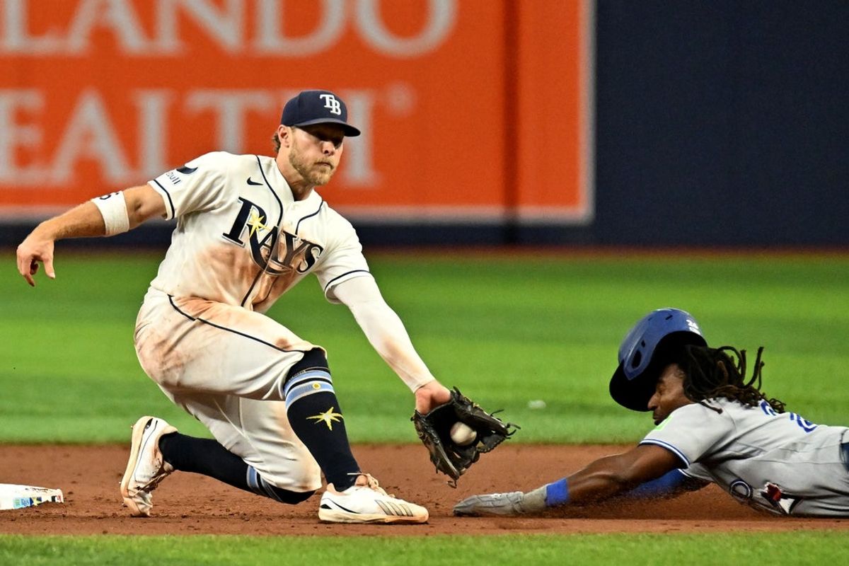 Aug 19, 2026; St. Petersburg, Florida, USA; Tampa Bay Rays shortstop Taylor Walls (6) catches the ball as Toronto Blue Jays third baseman Charles McAdoo (26) slides into second base in the ninth inning at Tropicana Field. Mandatory Credit: Jonathan Dyer-Imagn Images