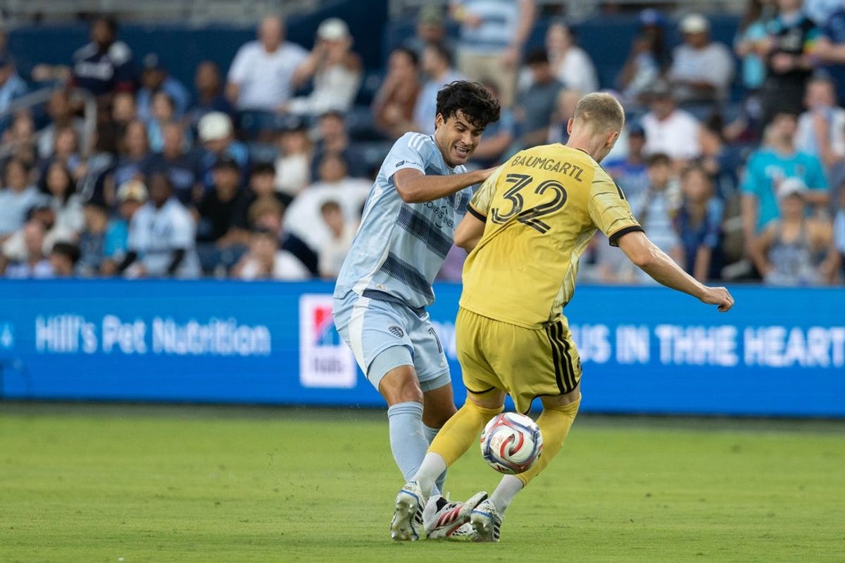 Aug 19, 2026; Kansas City, Kansas, USA; Sporting Kansas City forward Taylor Calheira (19) and St. Louis CITY SC defender Timo Baumgartl (32) compete for a ball during the first half at Children's Mercy Park. Mandatory Credit: Kylie Graham-Imagn Images