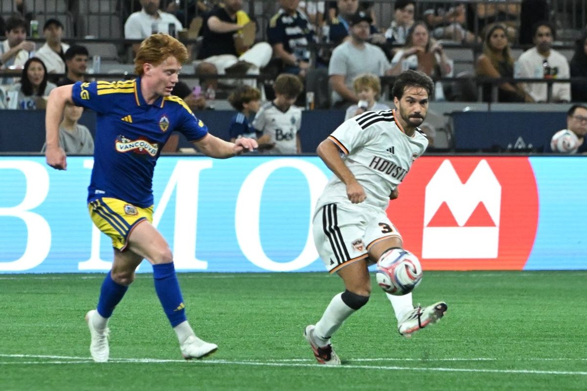 Aug 19, 2026; Vancouver, British Columbia, CAN;  Houston Dynamo midfielder Agustin Bouzat (30) passes the ball against Vancouver Whitecaps midfielder Oliver Larraz (8) during the second half at BC Place. Mandatory Credit: Simon Fearn-Imagn Images
