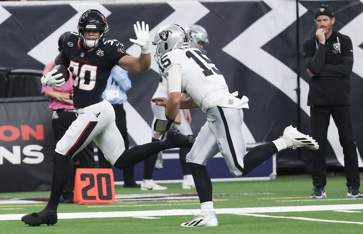 Aug 20, 2026; Houston, Texas, USA;  Houston Texans linebacker Wade Woodaz (30) returns Las Vegas Raiders quarterback Fernando Mendoza (15) interception for an 80 yard touchdown in the first quarter at Reliant Stadium.  Mandatory Credit: Thomas Shea-Imagn Images