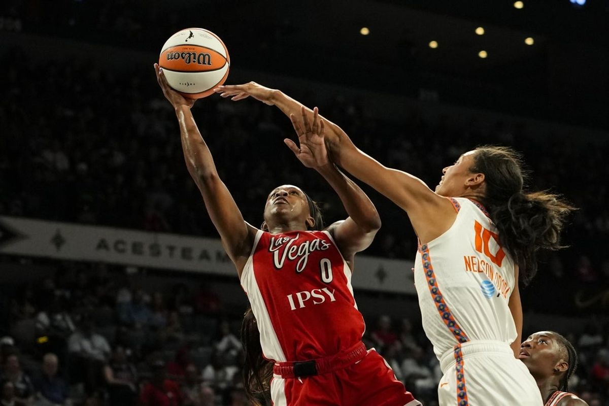 Aug 20, 2026; Las Vegas, Nevada, USA;  Las Vegas Aces guard Jackie Young (0) shoots a layup against Connecticut Sun center Olivia Nelson-Ododa (10) during the first quarter of a WNBA basketball game at Michelob Ultra Arena.  Mandatory Credit: Lucas Peltier-Imagn Images