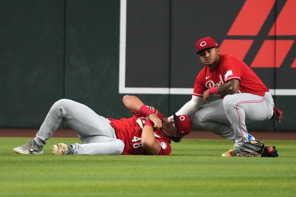 Aug 21, 2026; Phoenix, Arizona, USA;  Cincinnati Reds first baseman Michael Toglia (48) holds his shoulder after diving for the ball against the Arizona Diamondbacks in the first inning at Chase Field.  Mandatory Credit: Rick Scuteri-Imagn Images