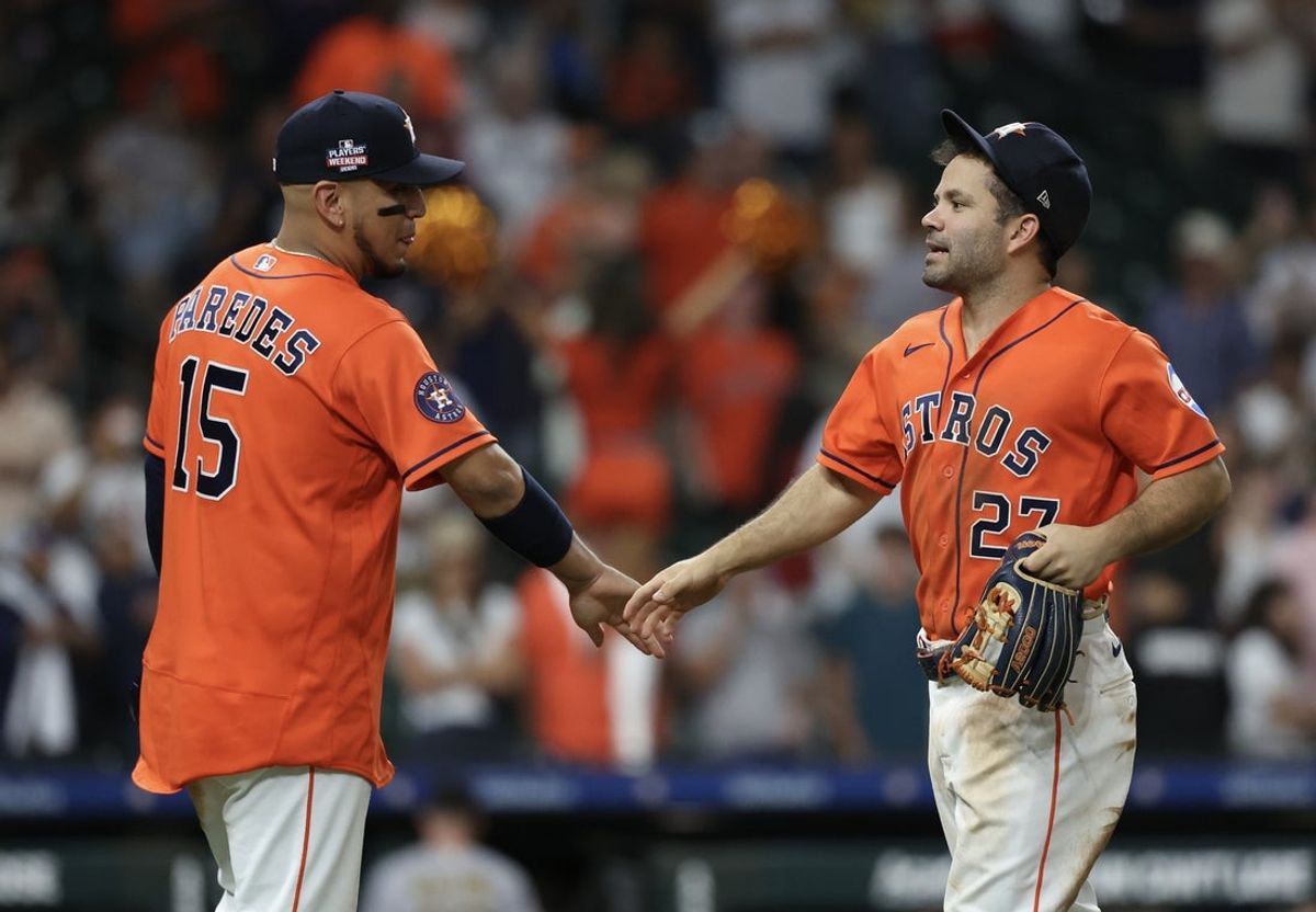 Aug 21, 2026; Houston, Texas, USA;  Houston Astros designated hitter Isaac Paredes (15) celebrates the win with  second baseman Jose Altuve (27) after defeating the Athletics  at Daikin Park.  Mandatory Credit: Thomas Shea-Imagn Images