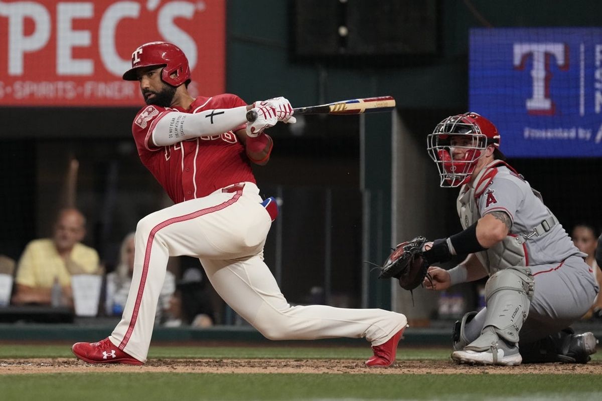 Aug 21, 2026; Arlington, Texas, USA;  Texas Rangers shortstop Ezequiel Duran (20) hits a walk-off single against the Los Angeles Angels during the tenth inning at Globe Life Field. Mandatory Credit: Raymond Carlin III-Imagn Images