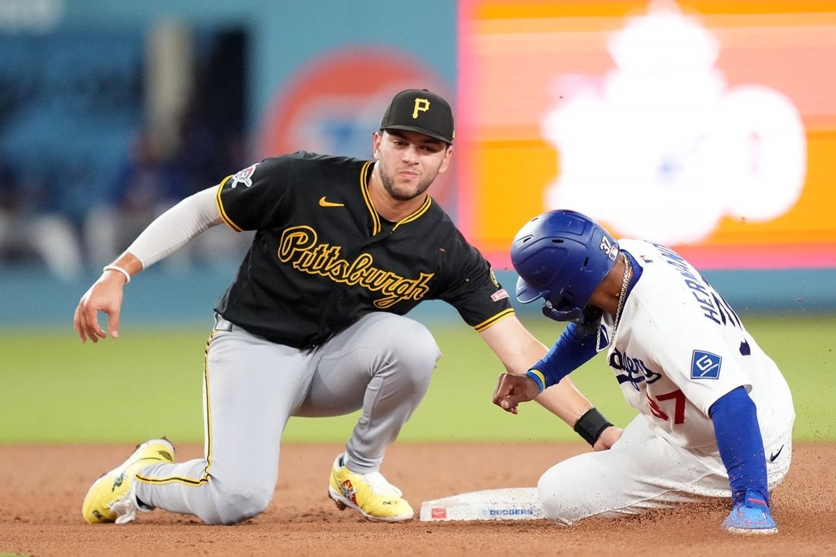 Aug 21, 2026; Los Angeles, California, USA;  Los Angeles Dodgers left fielder Teoscar Hernandez (37) is tagged out by Pittsburgh Pirates shortstop Jacob Gonzalez (26) during the fourth inning at Dodger Stadium. Mandatory Credit: Kirby Lee-Imagn Images