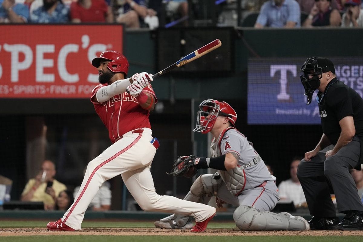 Aug 21, 2026; Arlington, Texas, USA;  Texas Rangers shortstop Ezequiel Duran (20) hits a double against the Los Angeles Angels during the ninth inning at Globe Life Field. Mandatory Credit: Raymond Carlin III-Imagn Images