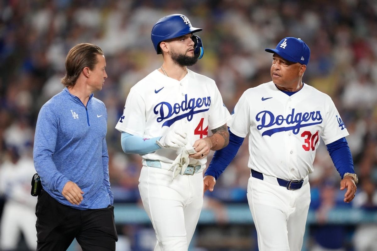 Aug 21, 2026; Los Angeles, California, USA; Los Angeles Dodgers center fielder Andy Pages (44) walks with head athletic trainer Thomas Albert (left) and manager Dave Roberts (30) after being hit by a pitch in the third inning against the Pittsburgh Pirates at Dodger Stadium. Mandatory Credit: Kirby Lee-Imagn Images