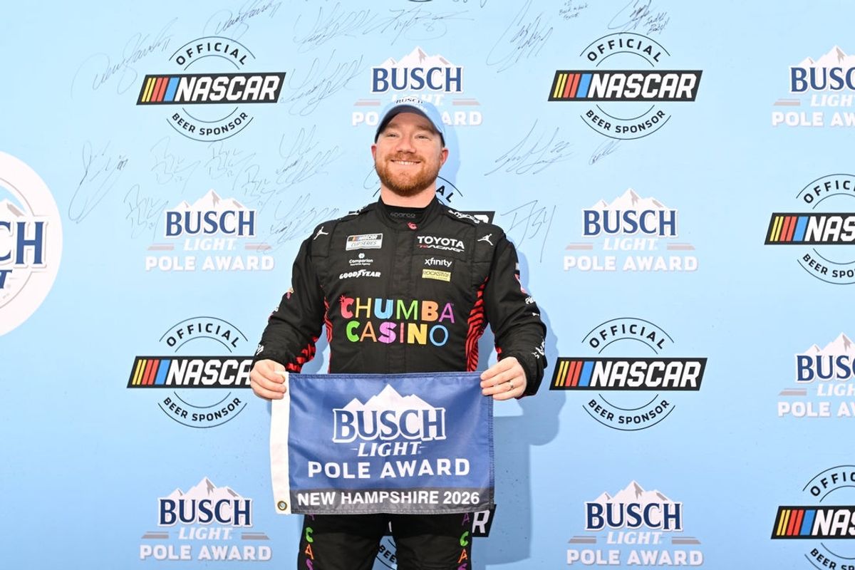 Aug 22, 2026; Loudon, New Hampshire, USA; 23XI Racing driver Tyler Reddick (45) stands with the Busch Light Pole Award after winning the pole for Dollar Tree 301 at New Hampshire Motor Speedway. Mandatory Credit: Eric Canha-Imagn Images