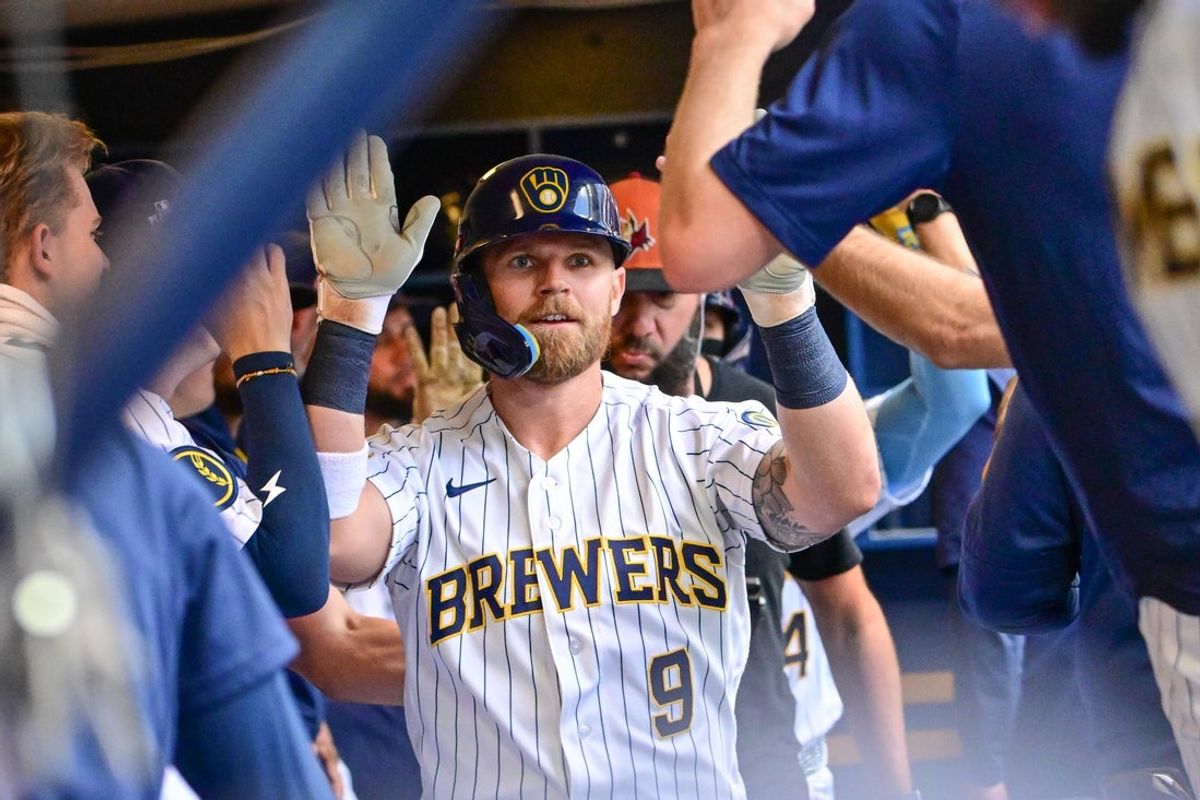 Aug 22, 2026; Milwaukee, Wisconsin, USA;  Milwaukee Brewers right fielder Jake Bauers (9) is greeted in the dugout after hitting a two run home run against the Atlanta Braves at American Family Field.  Mandatory Credit: Benny Sieu-Imagn Images