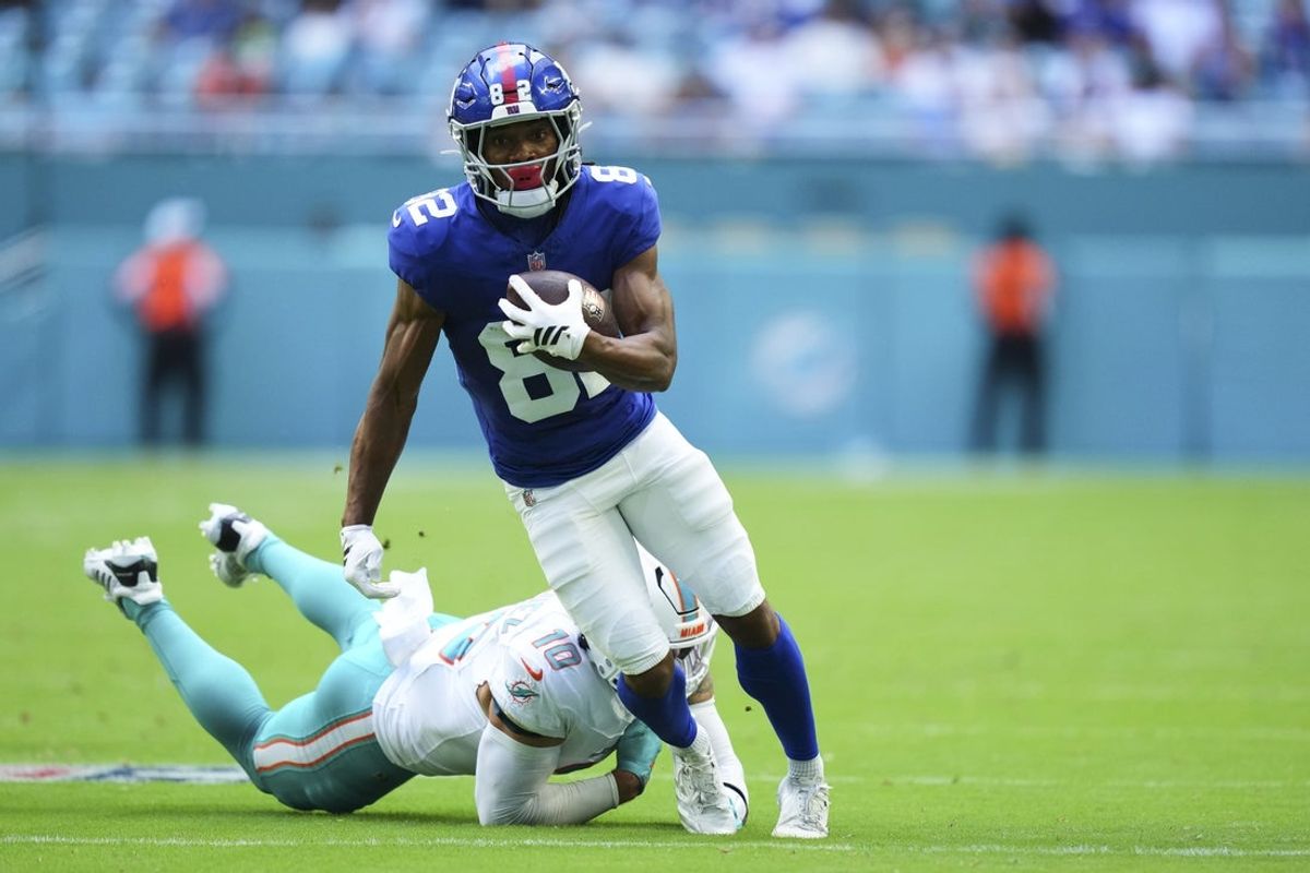 Aug 22, 2026; Miami Gardens, Florida, USA;  New York Giants wide receiver Calvin Austin III (82) breaks the tackle of Miami Dolphins linebacker Jacob Rodriguez (10) during the first quarter of a preseason game at Hard Rock Stadium.  Mandatory Credit: Rich Storry-Imagn Images