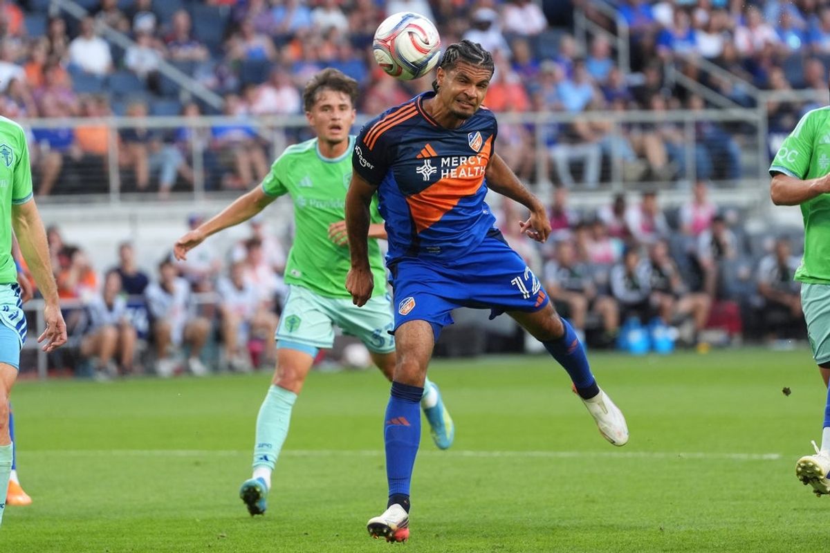 Aug 22, 2026; Cincinnati, Ohio, USA;  FC Cincinnati defender Miles Robinson (12) heads the ball toward the goal during the first half of a match against Seattle Sounders FC at TQL Stadium.  Mandatory Credit: Kareem Elgazzar-Imagn Images
