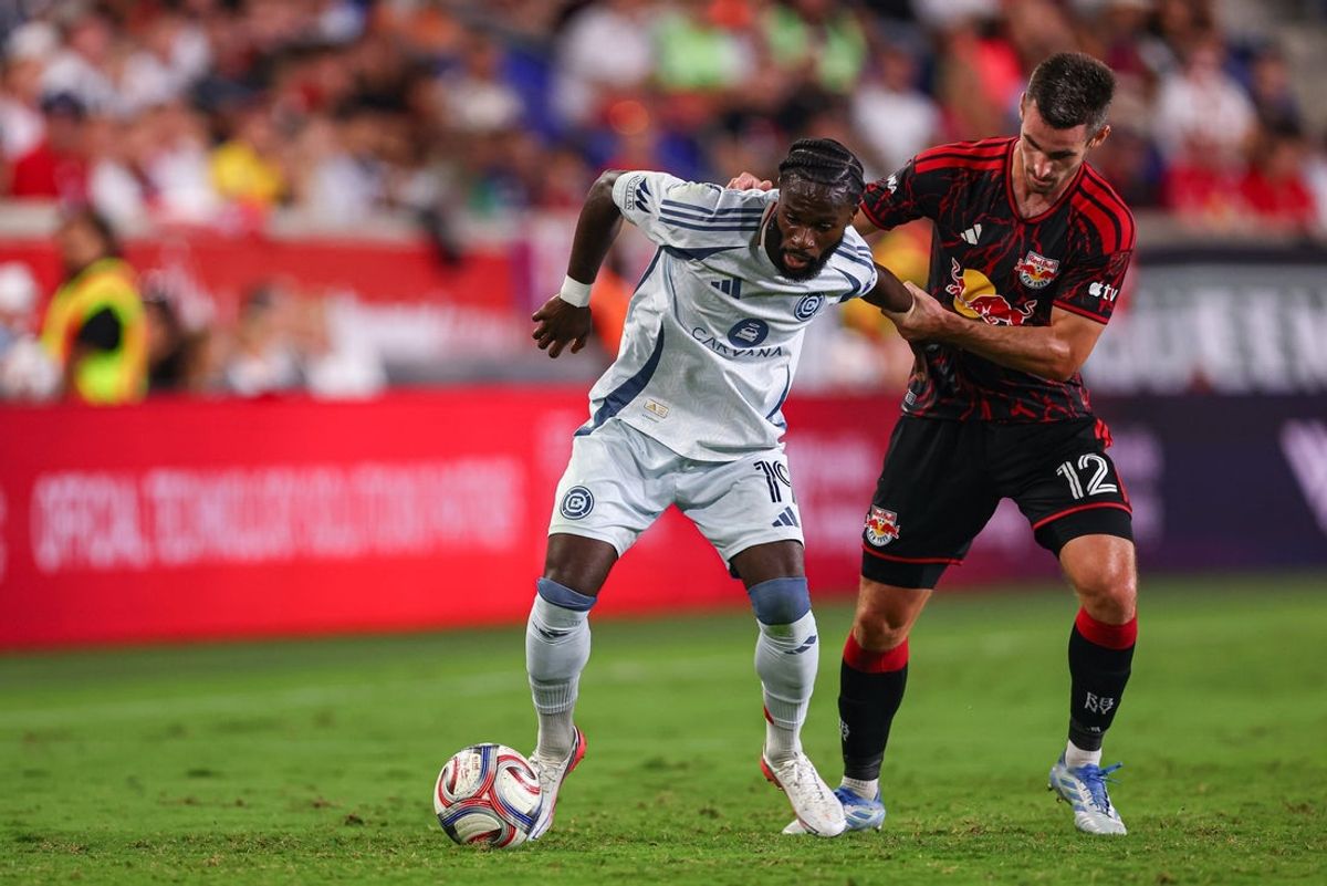 Aug 22, 2026; Harrison, New Jersey, USA;  Chicago Fire FC forward Jonathan Bamba (19) battle for the ball against Red Bull New York defense Dylan Nealis (12) in the first half at Sports Illustrated Stadium. Mandatory Credit: Vincent Carchietta-Imagn Images