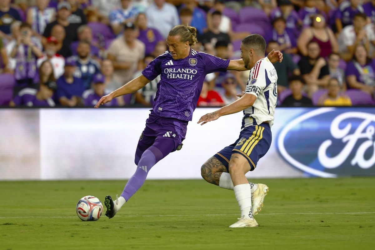 Aug 22, 2026; Orlando, Florida, USA;  Orlando City SC defender Griffin Dorsey (24) makes a crossing pass as Real Salt Lake defender Alexandros Katranis (98) defends in the first half at Inter&Co Stadium.  Mandatory Credit: Russell Lansford-Imagn Images