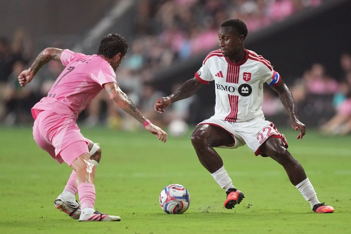 Aug 22, 2026; Miami, Florida, USA;  Toronto FC defender Richie Laryea (22) looks for space as Inter Miami midfielder Rodrigo de Paul (7) closes in during the first half at Miami Freedom Park.  Mandatory Credit: Jim Rassol-Imagn Images
