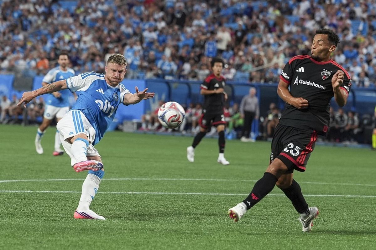 Aug 22, 2026; Charlotte, North Carolina, USA;  Charlotte FC midfielder Pep Biel (16) kicks the ball to the goal against D.C. United midfielder Brandon Servania (23) during the first half at Bank of America Stadium.  Mandatory Credit: Jim Dedmon-Imagn Images