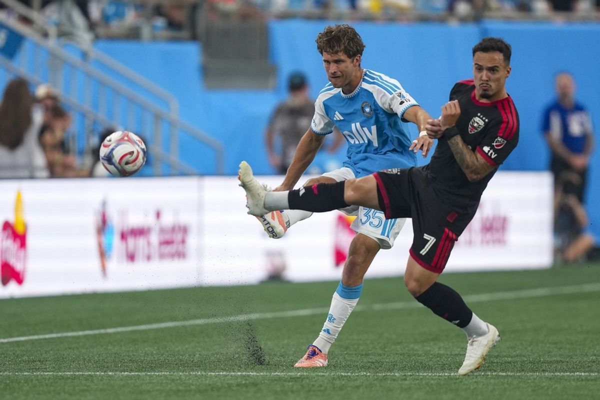 Aug 22, 2026; Charlotte, North Carolina, USA;  D.C. United forward Joao Peglow (7) kicks the ball defended by Charlotte FC defender Will Cleary (35) during the first half at Bank of America Stadium.  Mandatory Credit: Jim Dedmon-Imagn Images