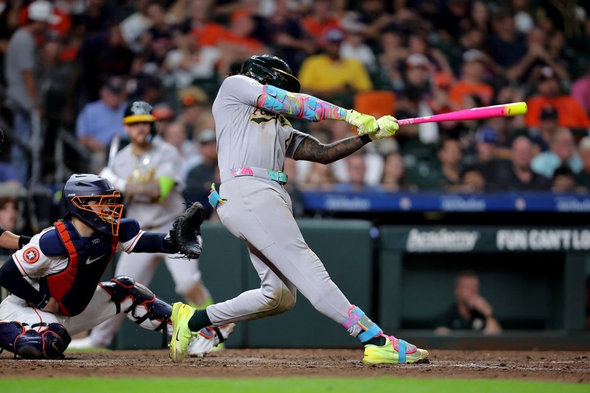 Aug 22, 2026; Houston, Texas, USA;  Athletics right fielder Lawrence Butler (4) hits an RBI single against the Houston Astros during the eighth inning at Daikin Park.  Mandatory Credit: Erik Williams-Imagn Images