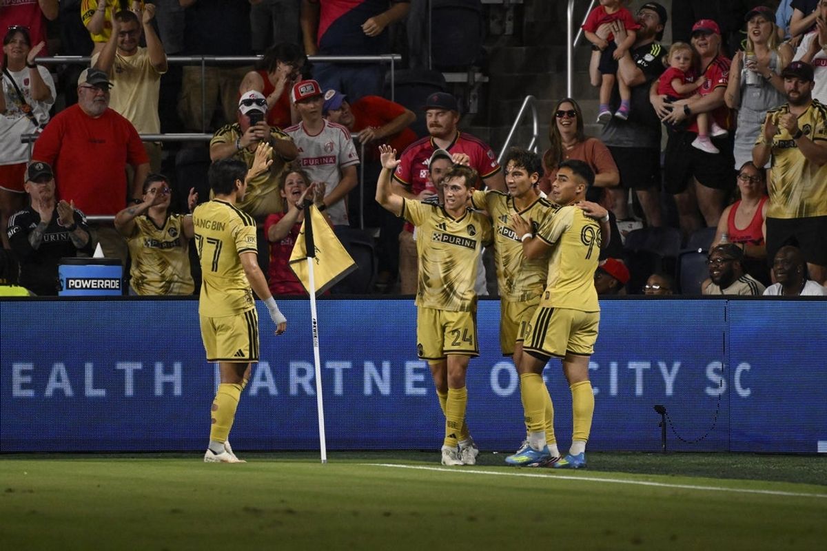 Aug 22, 2026; St. Louis, Missouri, USA;  St. Louis CITY SC forward Simon Becher (11) is congratulated after scoring against Houston Dynamo FC in the first half at Energizer Park.  Mandatory Credit: Joe Puetz-Imagn Images