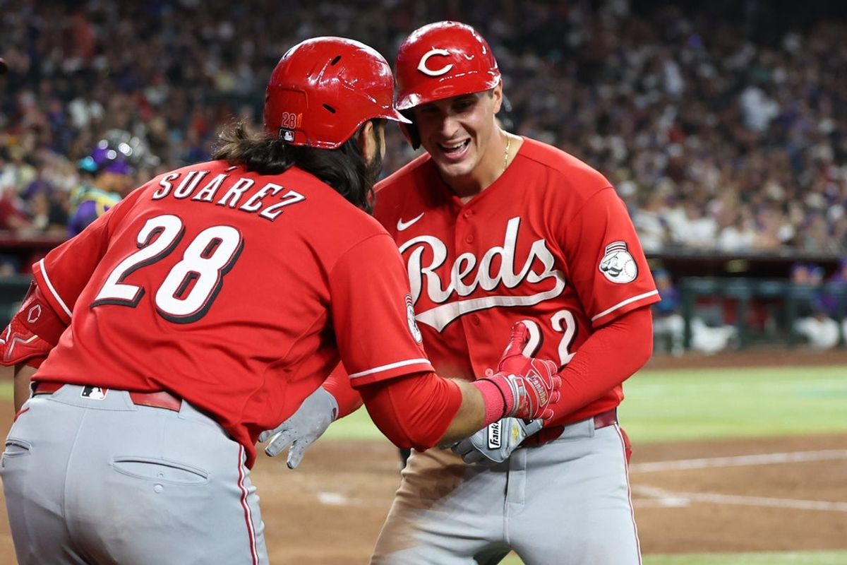 Aug 22, 2026; Phoenix, Arizona, USA;  Cincinnati Reds outfielder JJ Bleday (22) celebrates with Cincinnati Reds designated hitter Eugenio Suarez (28) after hitting a home run for the cycle against the Arizona Diamondbacks in the sixth inning at Chase Field.  Mandatory Credit: Anna Carrington-Imagn Images