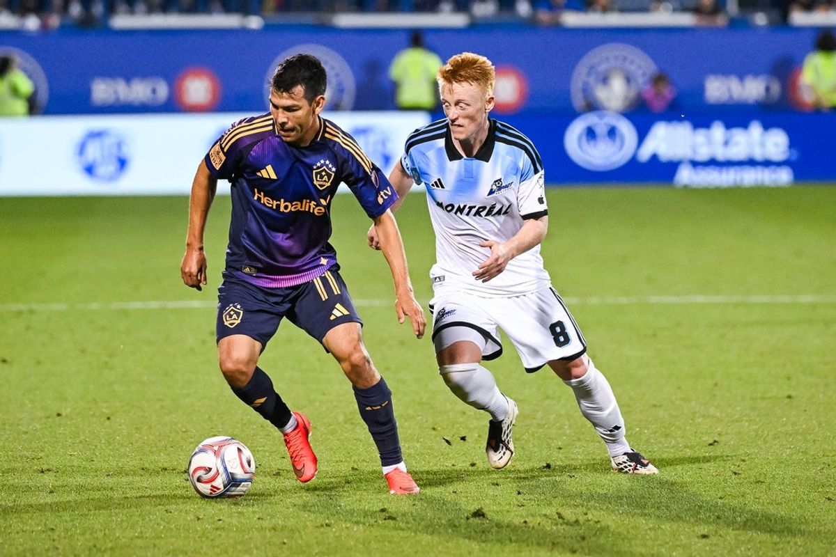 Aug 22, 2026; Montreal, Province of Quebec, CAN;  LA Galaxy forward Hirving Lozano (11) defends the ball agianst CF Montreal midfielder Matthew Longstaff (8) during the second half at Saputo Stadium.  Mandatory Credit: David Kirouac-Imagn Images