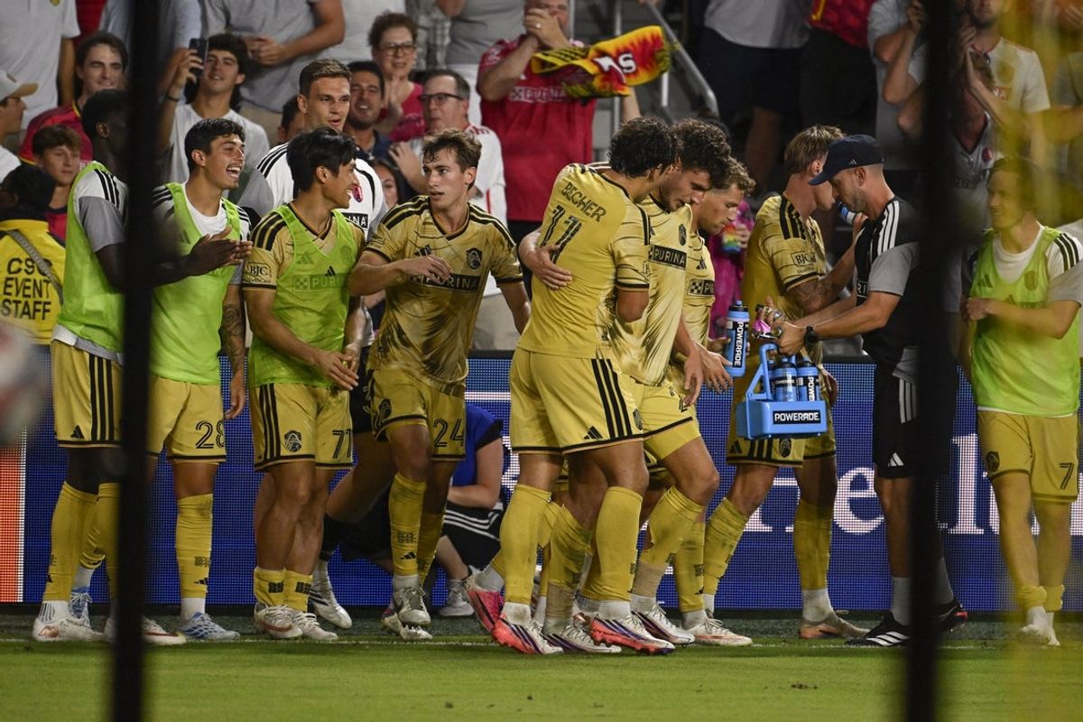 Aug 22, 2026; St. Louis, Missouri, USA;  St. Louis CITY SC midfielder Dante Polvara (21) is congratulated after scoring against Houston Dynamo FC in the second half at Energizer Park.  Mandatory Credit: Joe Puetz-Imagn Images