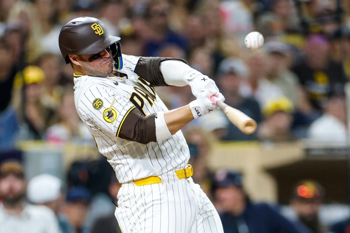 Aug 22, 2026; San Diego, California, USA;  San Diego Padres first baseman Ty France (25) hits a RBI single during the seventh inning against the Minnesota Twins at Petco Park.  Mandatory Credit: David Frerker-Imagn Images