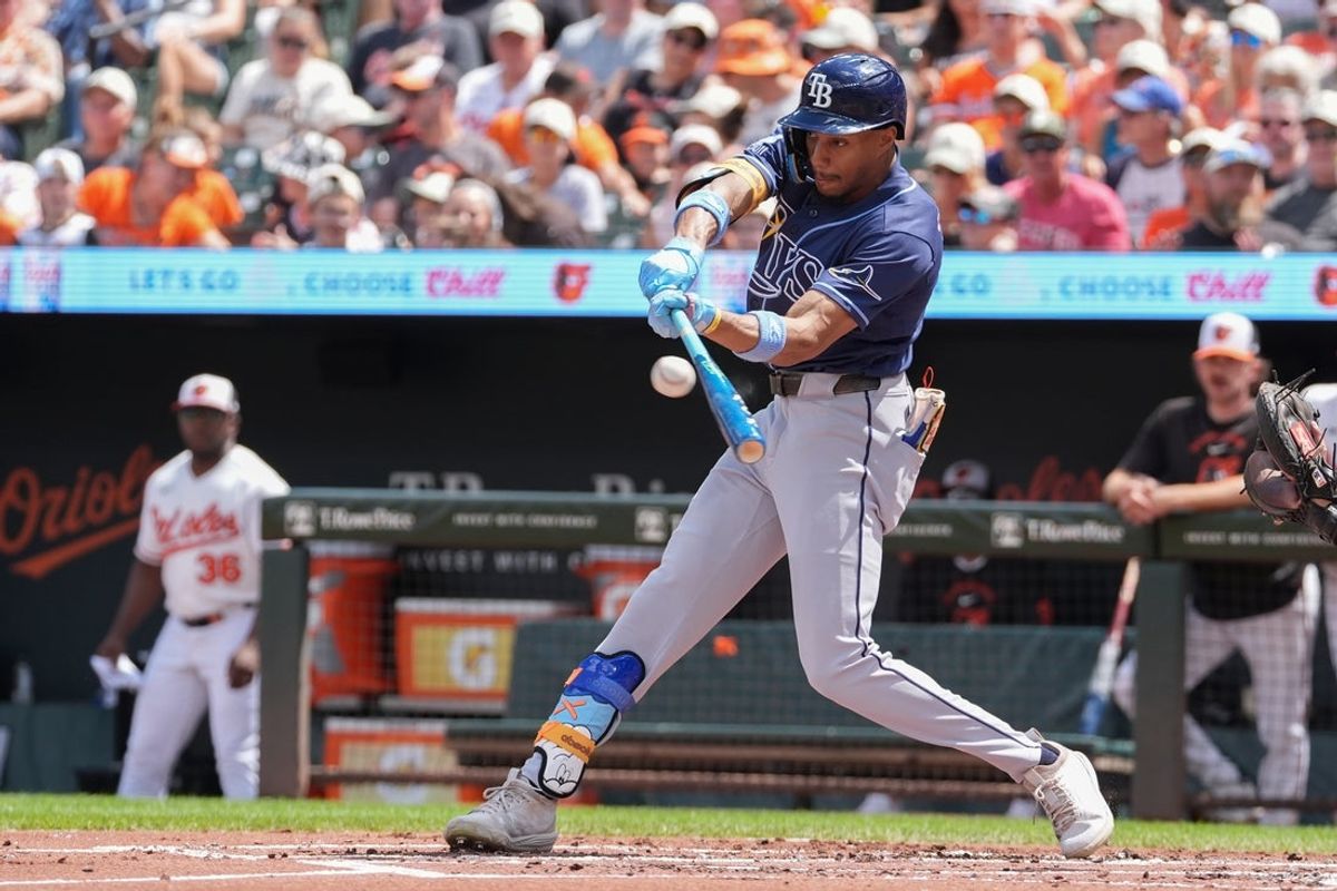 Aug 23, 2026; Baltimore, Maryland, USA;  Tampa Bay Rays left fielder Chandler Simpson (14) hits a single against the Baltimore Orioles during the second inning at Oriole Park at Camden Yards.  Mandatory Credit: Gregory Fisher-Imagn Images