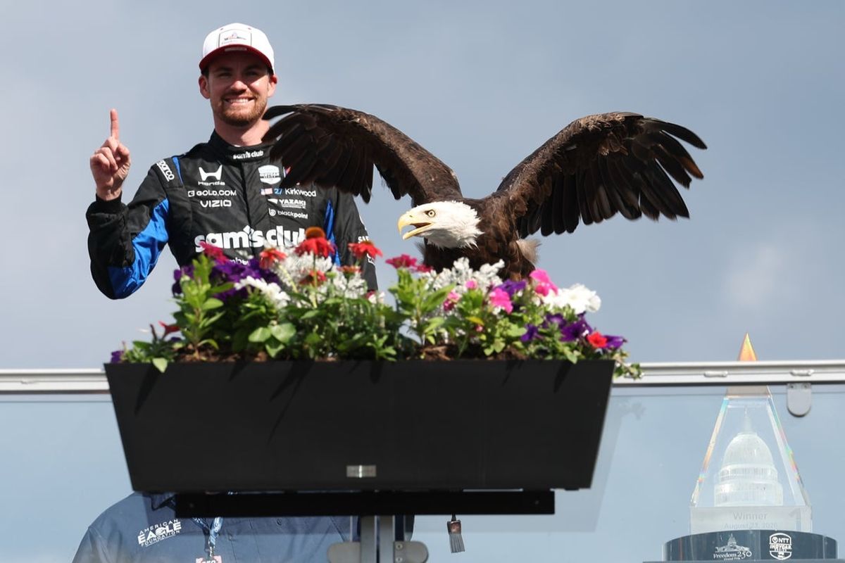 Aug 23, 2026; Washington, D.C., USA; Andretti Global driver Kyle Kirkwood (L) celebrates with Freedom the eagle on the podium after winning the Freedom 250 Grand Prix of Washington, D.C. on the street circuit at National Mall. Mandatory Credit: Amber Searls-Imagn Images