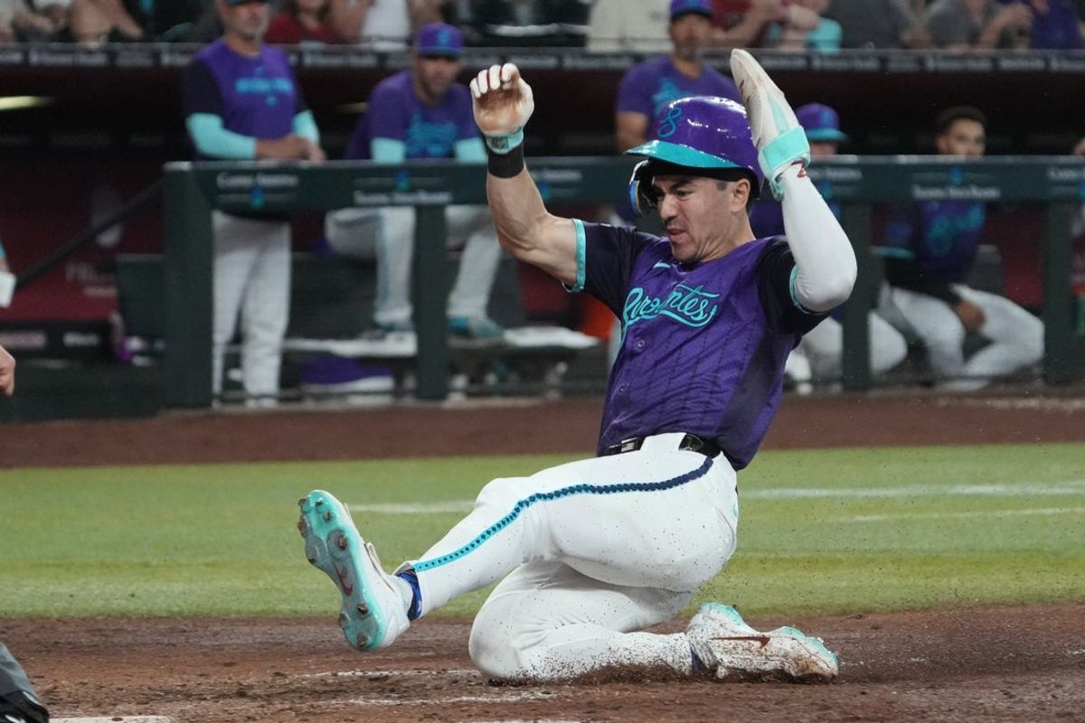 Aug 23, 2026; Phoenix, Arizona, USA;  Arizona Diamondbacks right fielder Corbin Carroll (7) scores a run against the Cincinnati Reds in the sixth inning at Chase Field.  Mandatory Credit: Rick Scuteri-Imagn Images