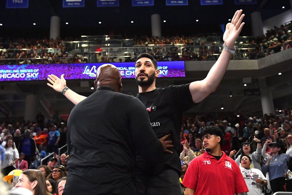 Aug 23, 2026; Chicago, Illinois, USA;  Turkish-American former basketball player and human rights activist Enes Kanter Freedom reacts as he is removed from the arena during the second half against the Indiana Fever at Wintrust Arena.  Mandatory Credit: Patrick Gorski-Imagn Images