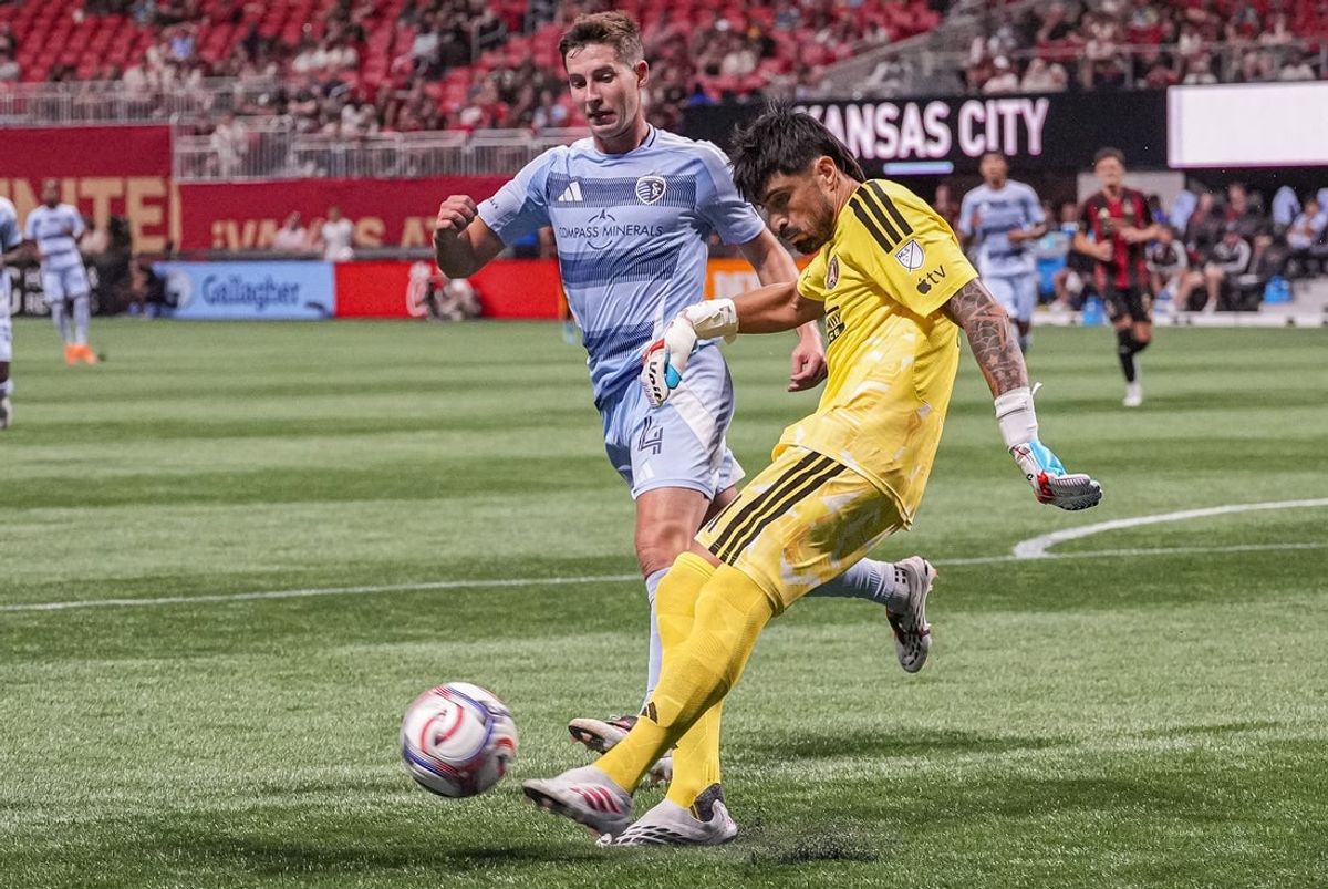 Aug 23, 2026; Atlanta, Georgia, USA; Atlanta United goalkeeper Lucas Hoyos (1) kicks the ball away from Sporting Kansas City midfielder Lasse Berg Johnsen (4) at Mercedes-Benz Stadium. Mandatory Credit: Dale Zanine-Imagn Images