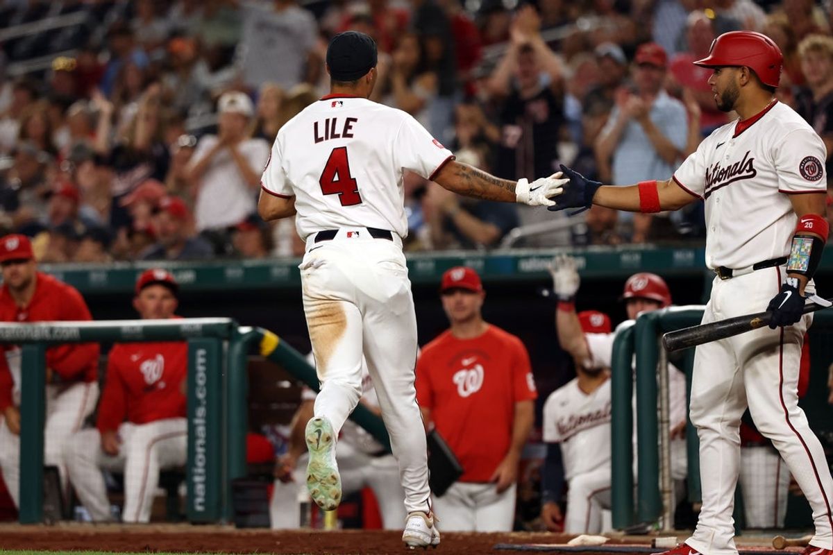 Aug 24, 2026; Washington, District of Columbia, USA;  Washington Nationals outfielder Daylen Lile (4) celebrates with catcher Keibert Ruiz (20) after scoring a run after an error during the fifth inning against the Colorado Rockies at Nationals Park.  Mandatory Credit: Geoff Burke-Imagn Images