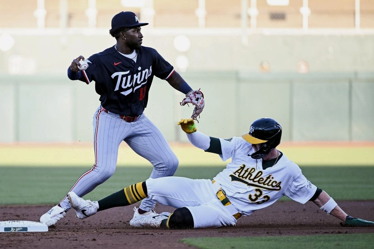 Aug 24, 2026; West Sacramento, California, USA;  Minnesota Twins shortstop Kaelen Culpepper (12) attempts to turn a double play against Athletics center fielder Henry Bolte (33) during the second inning at Sutter Health Park.  Mandatory Credit: Ed Szczepanski-Imagn Images
