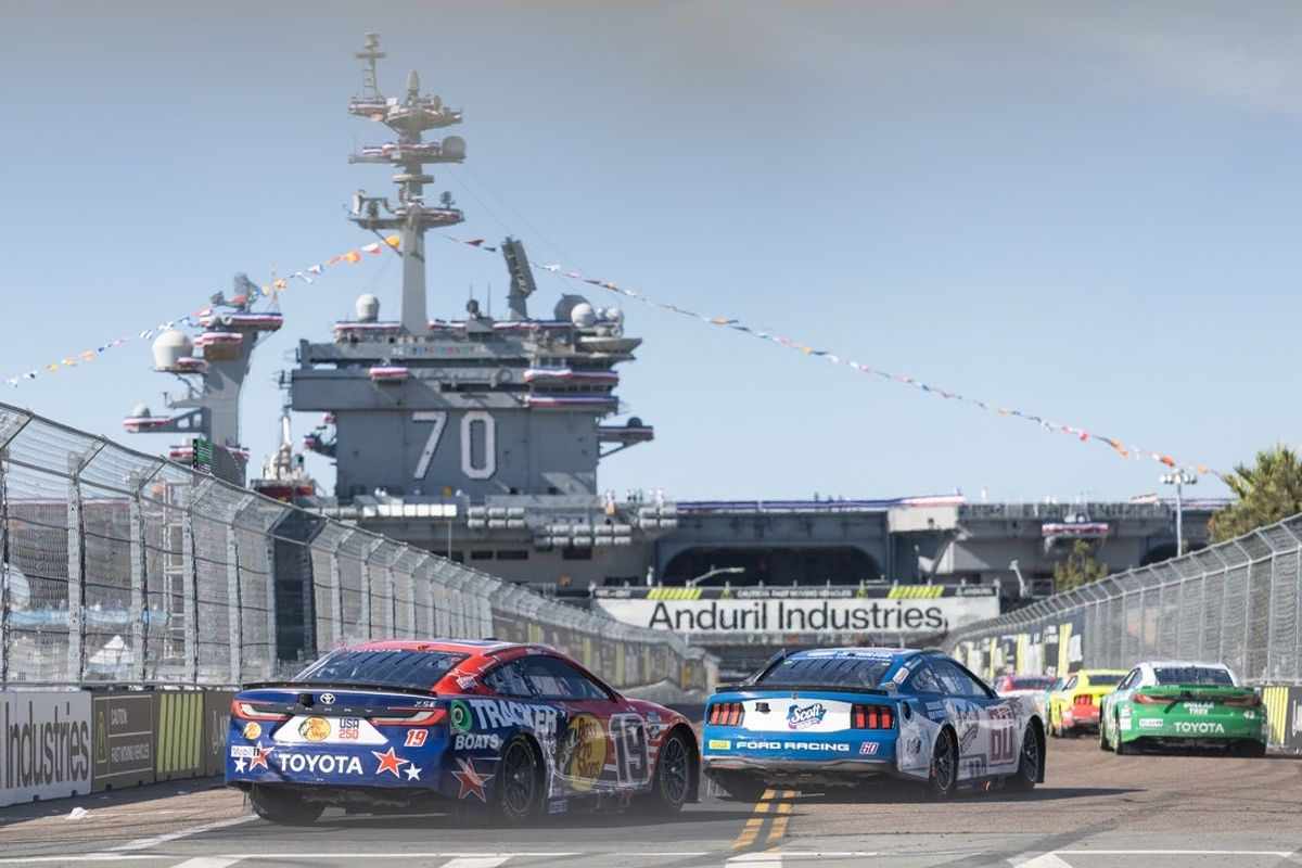 Jun 21, 2026; San Diego, California, USA; NASCAR Cup Series driver Chase Briscoe (19) drives near the Aircraft Carrier USS Carl Vinson (CVN-70) during the NASCAR Cup Series Anduril 250 at Naval Base Coronado. Mandatory Credit: Karl Anderson-Imagn Images
