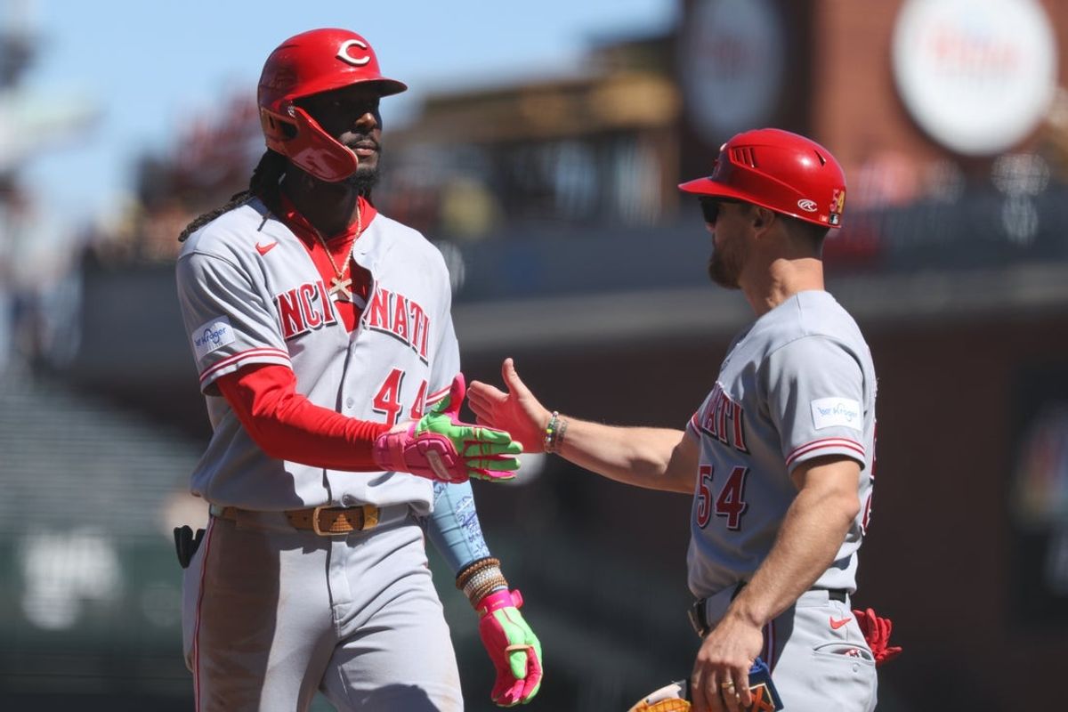 Aug 26, 2026; San Francisco, California, USA;  Cincinnati Reds shortstop Elly de la Cruz (44) shakes hands with first base coach Collin Cowgill (54) after a hitting a single during the seventh inning against the San Francisco Giants at Oracle Park.  Mandatory Credit: Sergio Estrada-Imagn Images