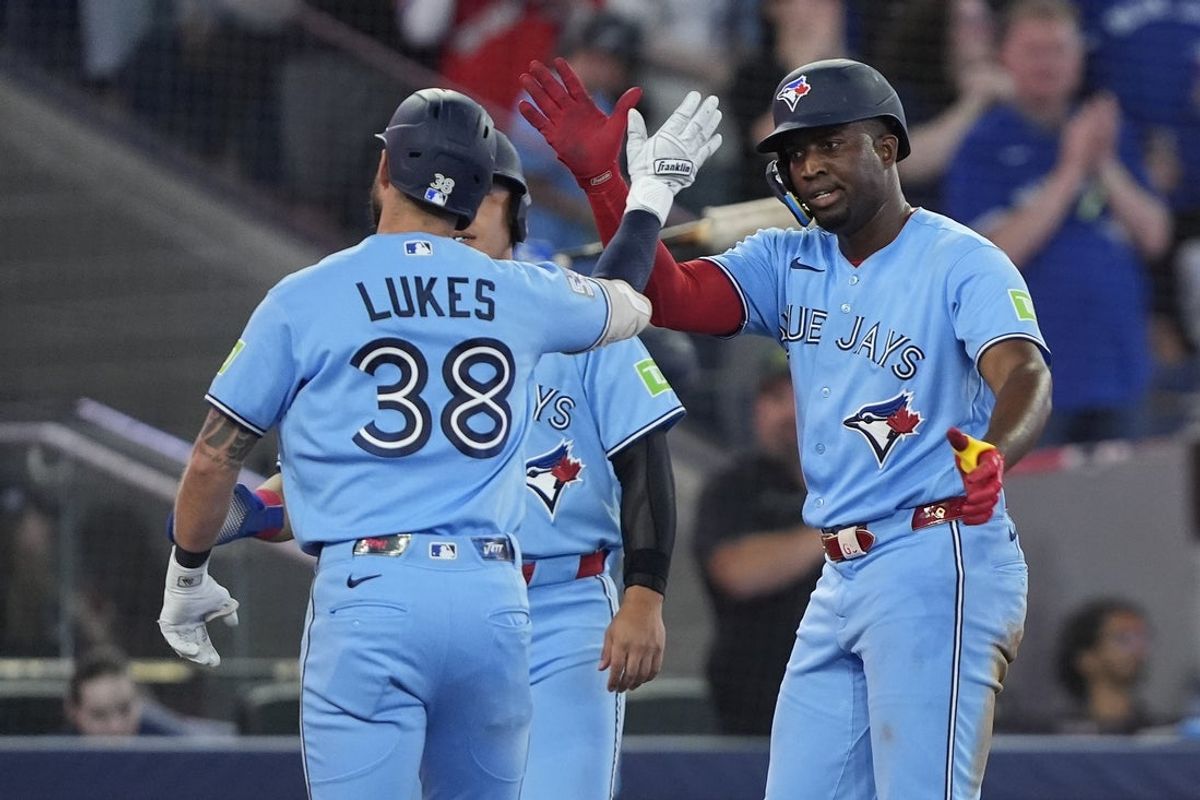 Aug 26, 2026; Toronto, Ontario, CAN;  Toronto Blue Jays left fielder Jesus Sanchez (12) congratulates right fielder Nathan Lukes (38) on his three run home run against the Kansas City Royals during the fourth inning at Rogers Centre.  Mandatory Credit: John E. Sokolowski-Imagn Images