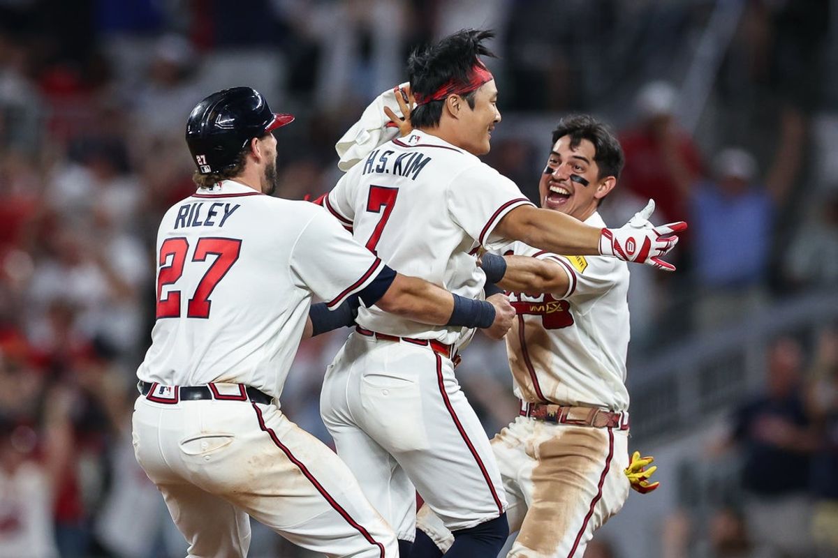 Aug 26, 2026; Cumberland, Georgia, USA;  Braves shortstop Ha-Seong Kim (7), celebrates with third baseman Austin Riley (27) and shortstop Mauricio Dubon (14) after hitting a walk-off RBI single against the Los Angeles Dodgers in the ninth inning at Truist Park.  Mandatory Credit: Colin Hubbard-Imago Images