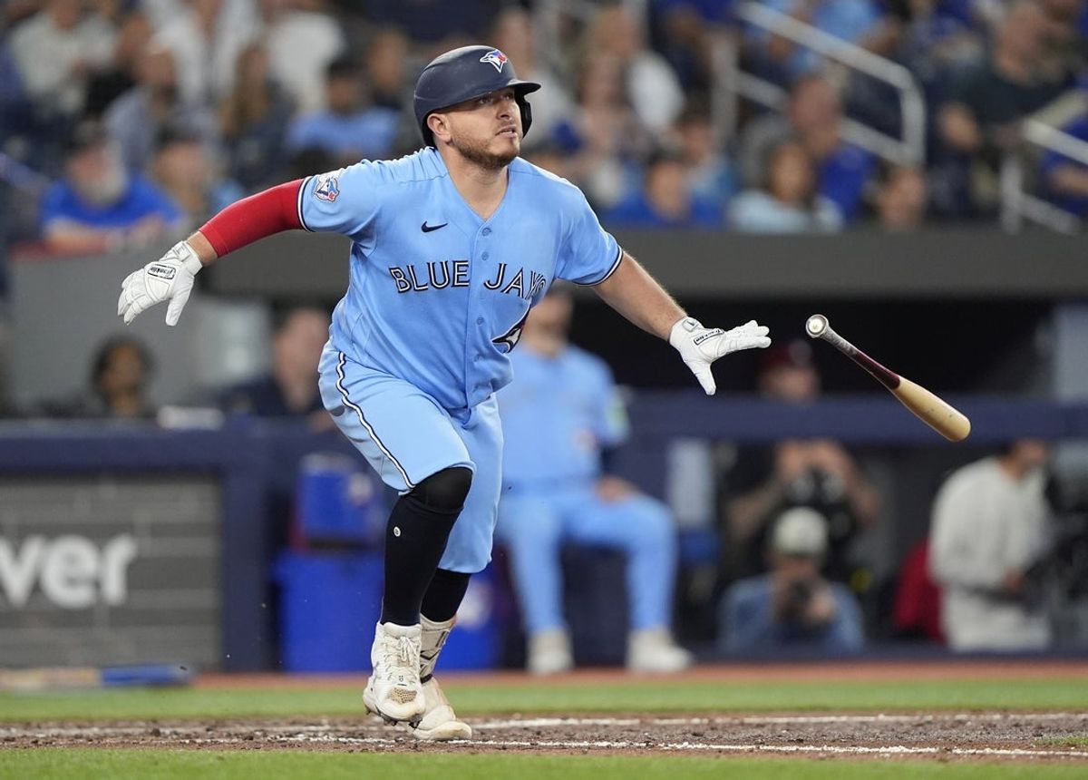 Aug 27, 2026; Toronto, Ontario, CAN;  Toronto Blue Jays catcher Alejandro Kirk (30) hits a single during the sixth inning against the Kansas City Royals at Rogers Centre.  Mandatory Credit: John E. Sokolowski-Imagn Images
