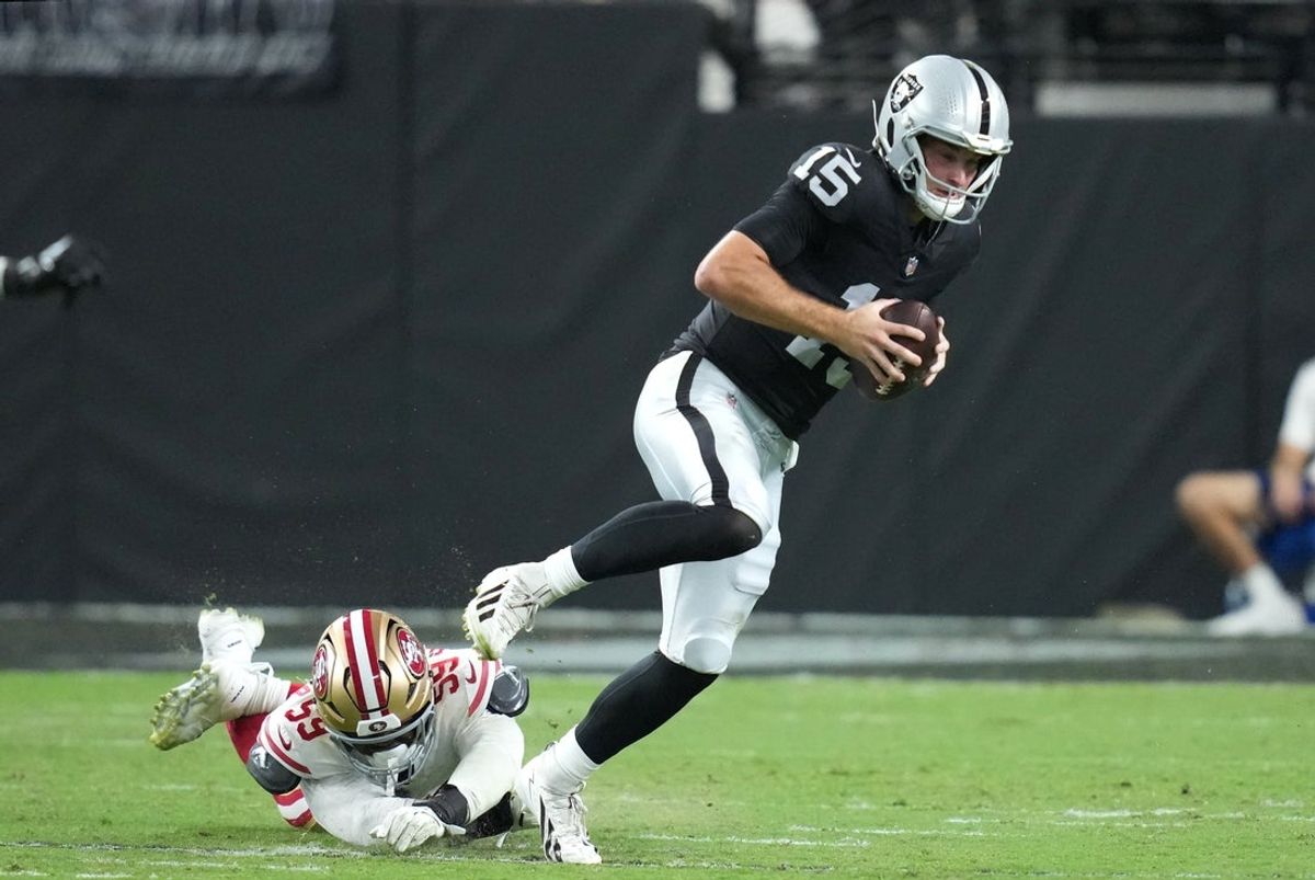 Aug 27, 2026; Paradise, Nevada, USA;  Las Vegas Raiders quarterback Fernando Mendoza (15) scrambles against San Francisco 49ers linebacker Ogbo Okoronkwo (59) during the third quarter at Allegiant Stadium.  Mandatory Credit: Kirby Lee-Imagn Images
