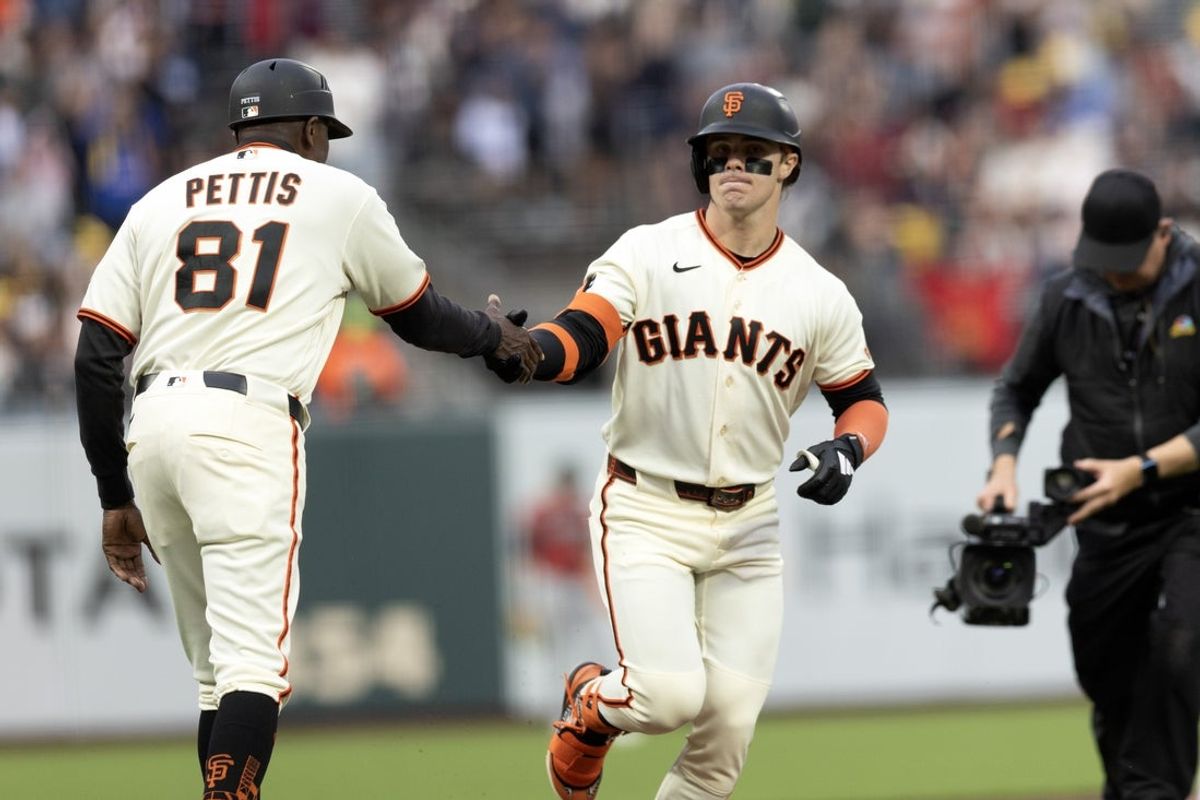 Aug 27, 2026; San Francisco, California, USA;  San Francisco Giants center fielder Drew Gilbert (right) gets a congratulatory handshake from third base coach Gary Pettis (81) during the first inning against the Arizona Diamondbacks at Oracle Park.  Mandatory Credit: D. Ross Cameron-Imagn Images