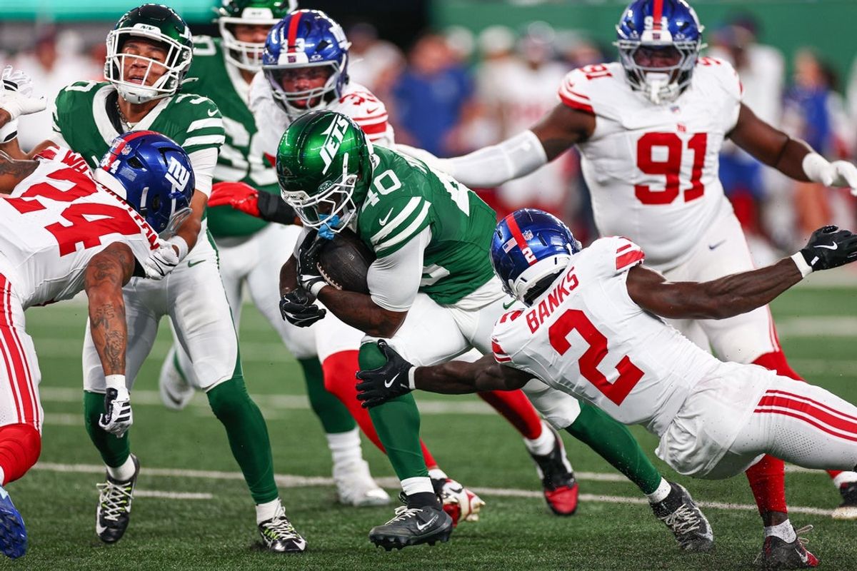 Aug 28, 2026; East Rutherford, New Jersey, USA; New York Jets running back Chip Trayanum (40) is tackled by New York Giants cornerback Deonte Banks (2) during the first half at MetLife Stadium. Mandatory Credit: Vincent Carchietta-Imagn Images