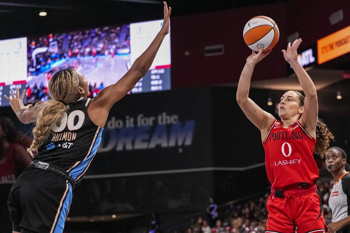 Aug 28, 2026; College Park, Georgia, USA; Portland Fire guard Carla Leite (0) shoots over Atlanta Dream forward Naz Hillmon (00) during the first half at Gateway Center Arena at College Park. Mandatory Credit: Dale Zanine-Imagn Images